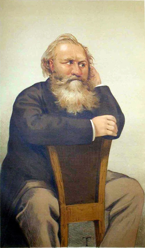 A portrait of a seated man with a long beard and thoughtful expression, wearing a dark coat and light pants, leaning on the back of a wooden chair.