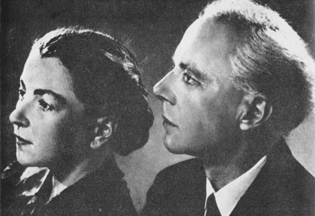 A black and white profile portrait of a woman and a man, both looking thoughtfully to the side.