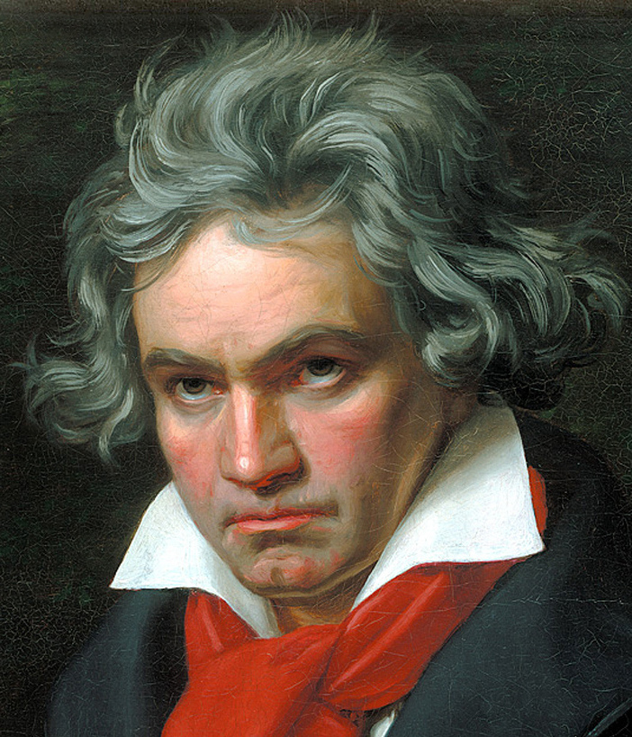 A portrait of a man with wavy gray hair, dressed in a black coat and a white collar with a red scarf, looking seriously at the viewer.